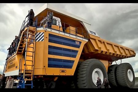 The BelAZ 75710 is the world's largest dump truck — note people in the bottom right for scale. 