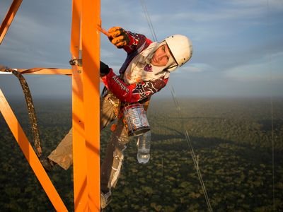A worker puts finishing paint touches on the Amazon Tall Tower Observatory in January