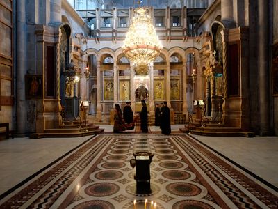 Greek Orthodox priests taking part in a procession inside the Katholikon, or Catholicon Chapel, in the Church of the Holy Sepulcher in Jerusalem.