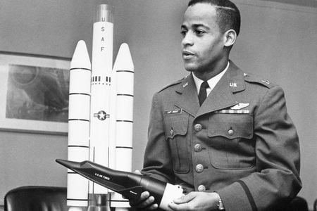 Captain Edward J. Dwight, Jr., the first African American selected as a potential astronaut, looks over a model of Titan rockets in November 1963.