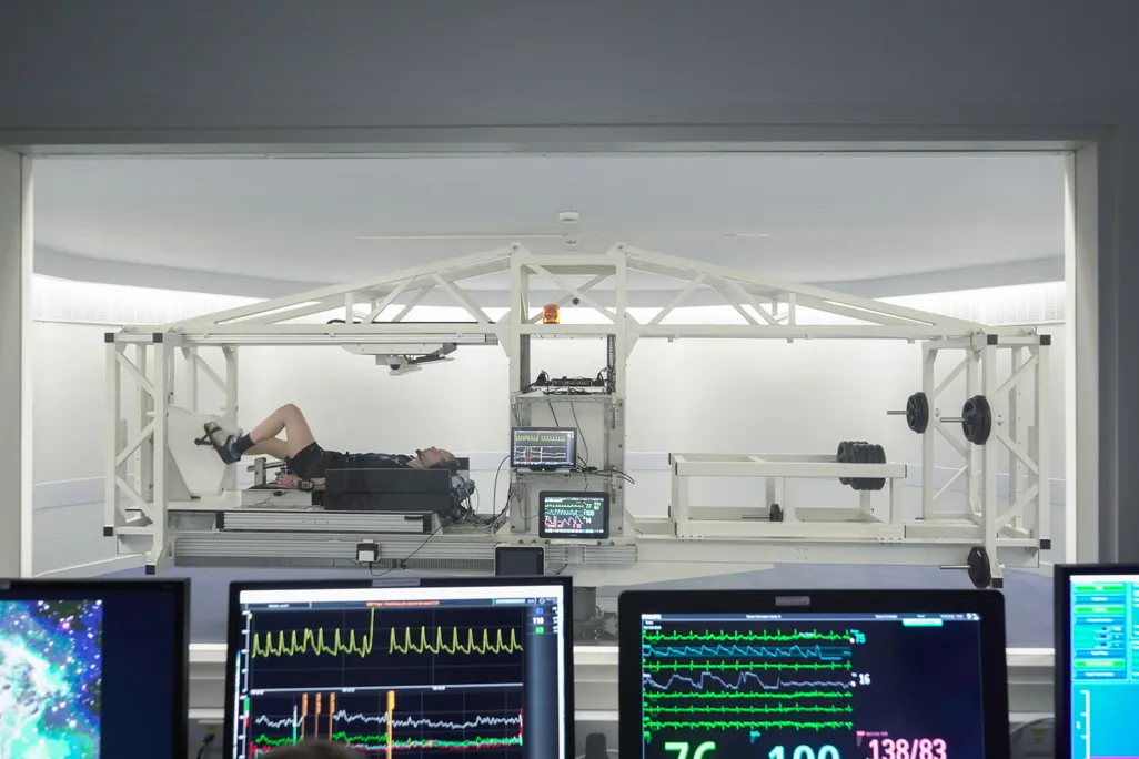 Man lying down while cycling in a lab