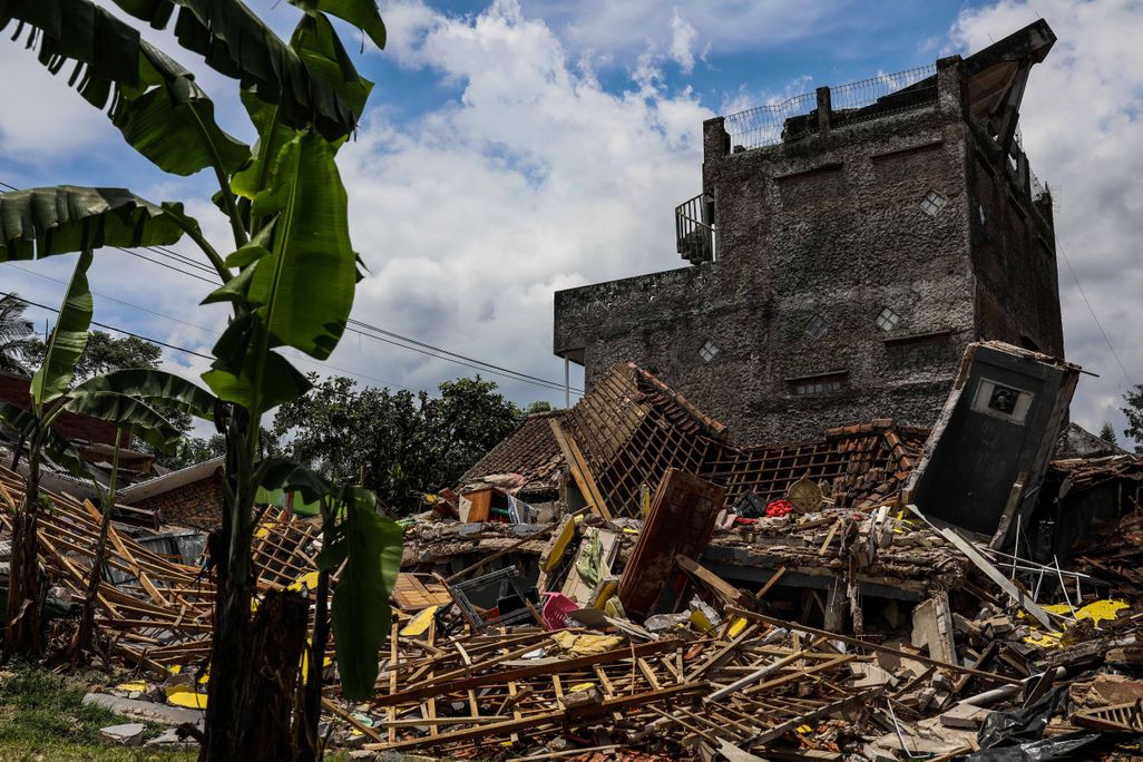 Rubble lies on the ground from a house damaged by the earthquake