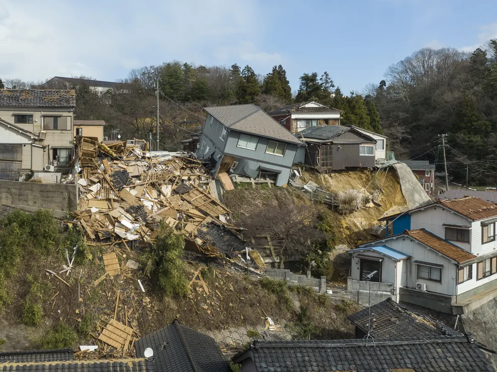 damaged houses on a cliffside