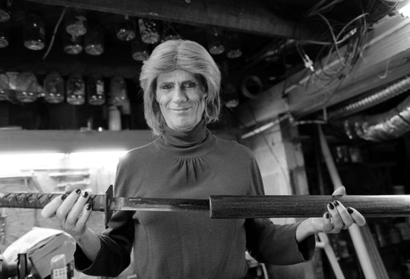 Joni - a southern, trans woman, and woodworker - showing her wooden sword sheath thumbnail