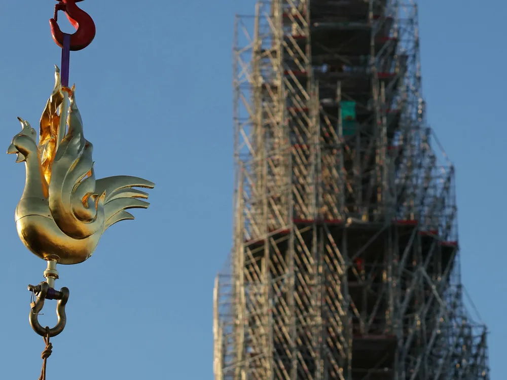Crane lifts golden rooster