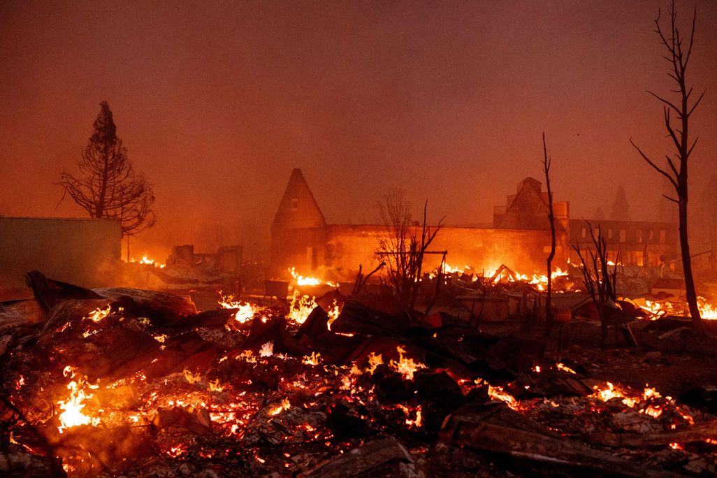 Buildings burn as the Dixie fire tears through downtown Greenville, California on August 4, 2021.