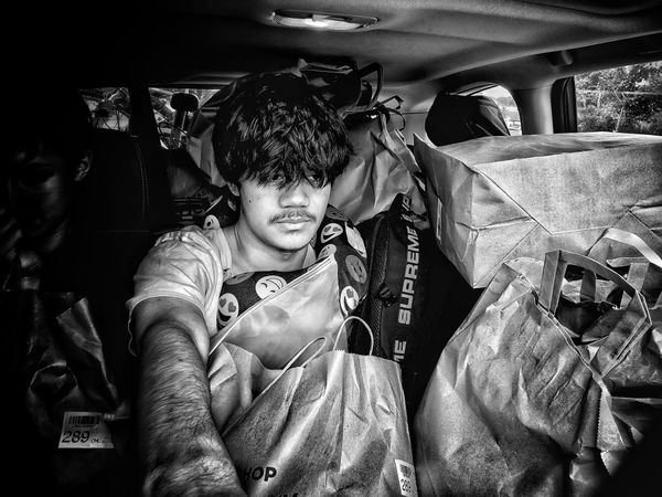 My Son in a car loaded with shopping bags thumbnail
