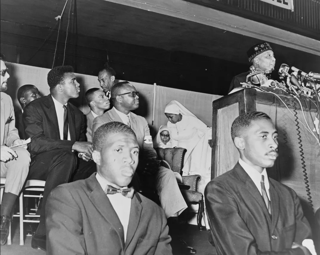 Cassius Clay attends a speech by Nation of Islam leader Elijah Muhammad