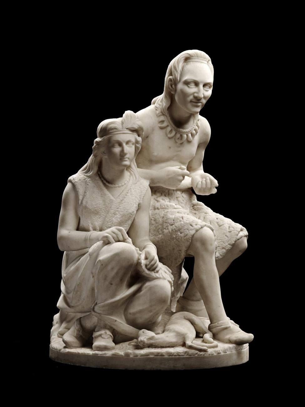 A white marble sculpture of a Native American man and woman sitting