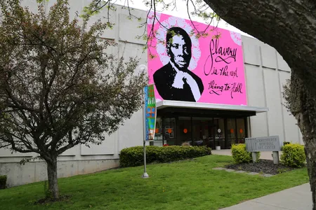 Measuring 32 feet in size, the massive "yarn bomb" of Harriet Tubman now hangs outside the Schweinfurth Art Center in Auburn, New York.