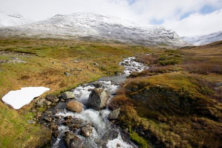 A hiker is dwarfed by the landscape of the mountain plateau where the Viking sword was found