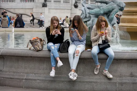 The impulse to check your phone after someone nearby checks theirs is an example of the chameleon effect, new research suggests. 