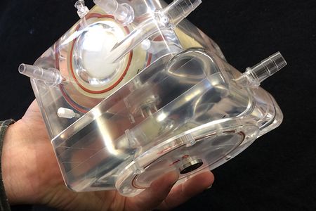 The mechanical lung would function outside the patient's body.