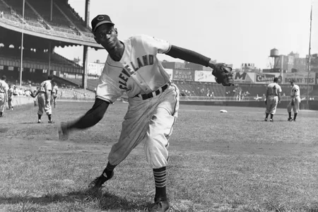 Satchel Paige pitches during warmups for Cleveland on August 30, 1948. Signed midway through the MLB season, Paige became the first African American to pitch in the American League.