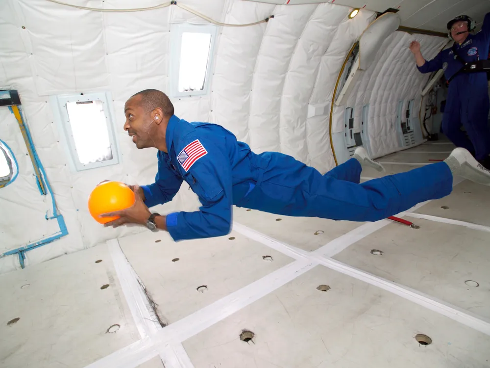 A person floats horizontally on a zero-gravity flight
