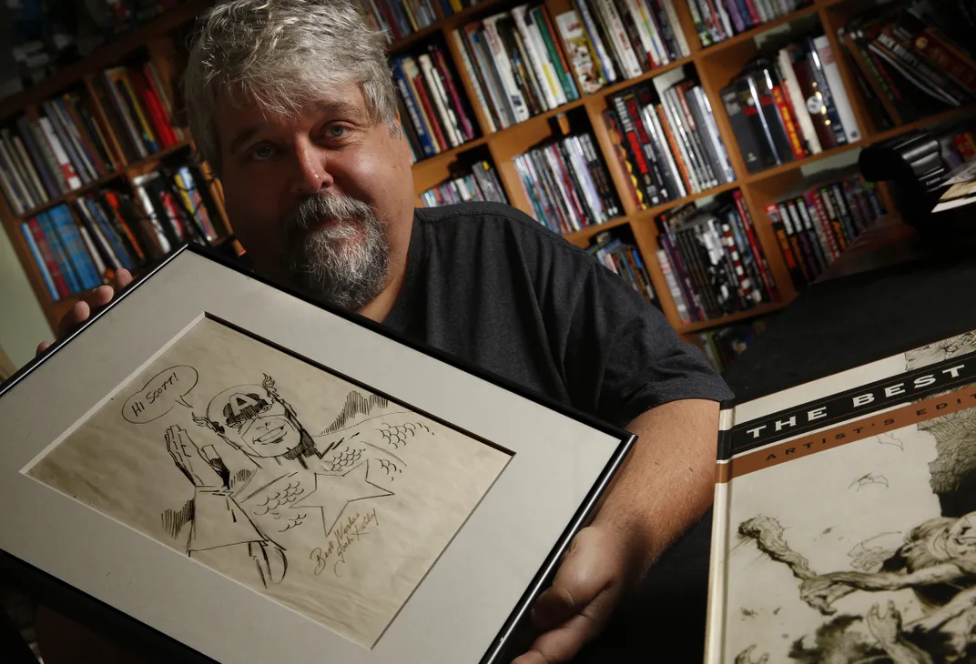 Scott Dunbier holds an original pencil sketch of Captain America