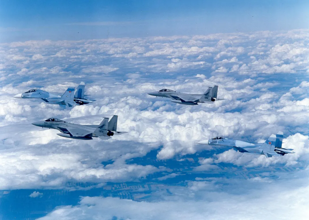 Su-27 escorted by F-15s in clouds