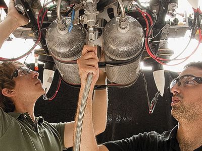 Draper Lab team members Bobby Cohanim (in black shirt) and Eph Lanford check fittings and connections on TALARIS before running a test.