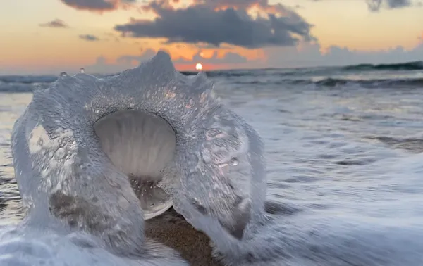 Wave crashing over lens ball thumbnail