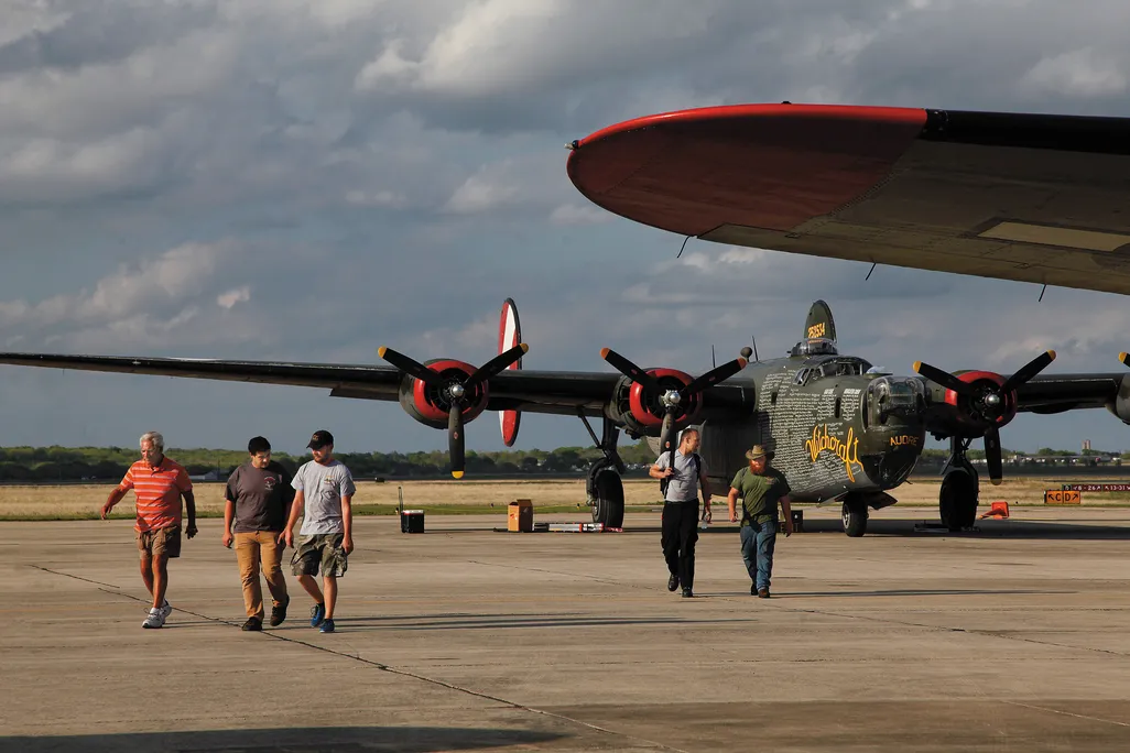 the roadies walk away from the last B-24J left flying