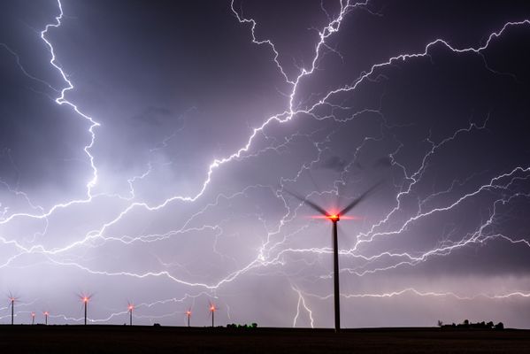 A massive lightning strike over miles of wind farms thumbnail