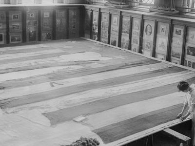 A conservator works on the Star-Spangled Banner in 1914.