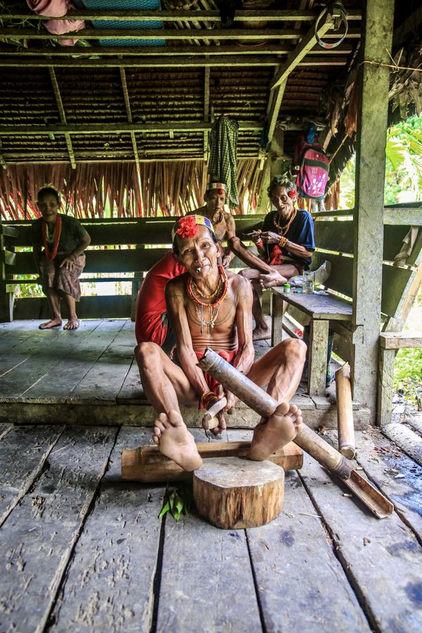 A Mentawai tribal man at work with a bamboo pole thumbnail