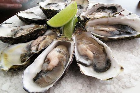 To lower one's risk of contracting infection, avoid eating raw or undercooked shellfish and cover open wounds with bandages before venturing into the water