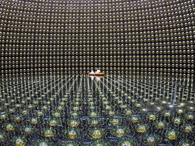 The cavernous Super-Kamiokande detector in Japan is lined with 13,000 sensors to pinpoint signs of neutrinos.