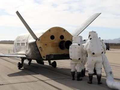 A little mystery: The Air Force X-37B mini-shuttle gets serviced after its landing at Vandenberg AFB in California last October.