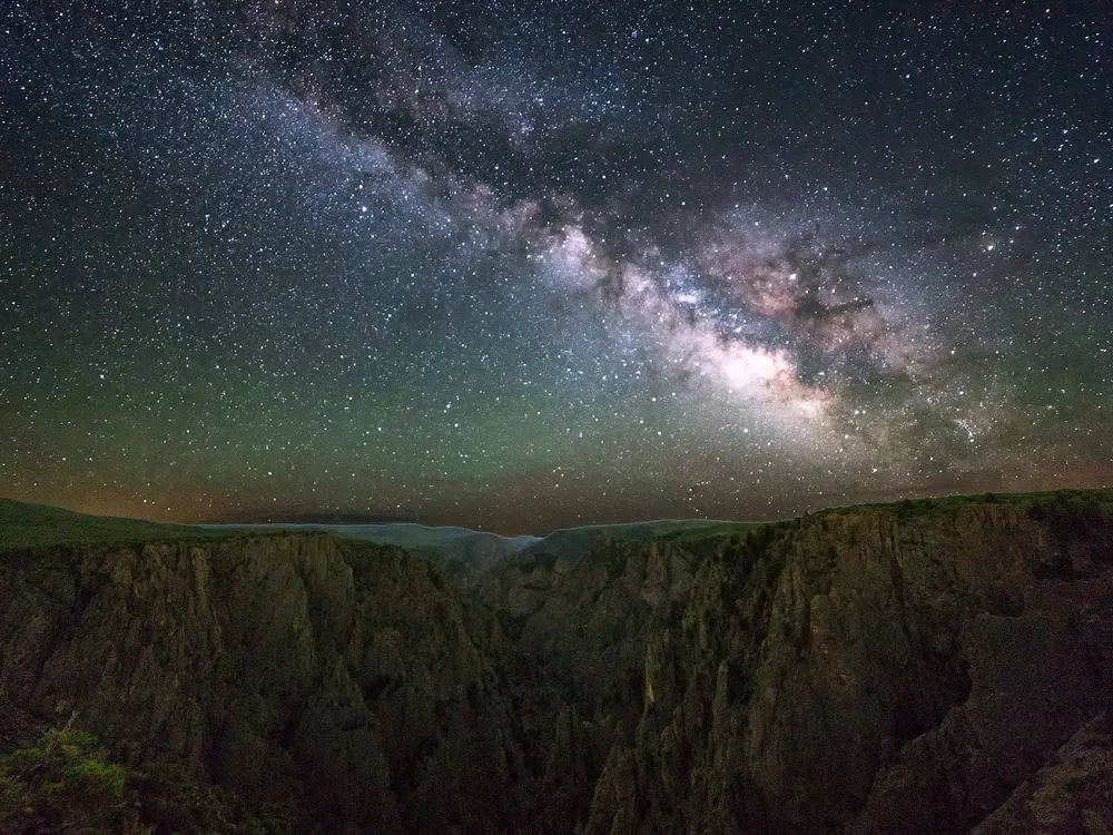 Milky Way over a dark landscape
