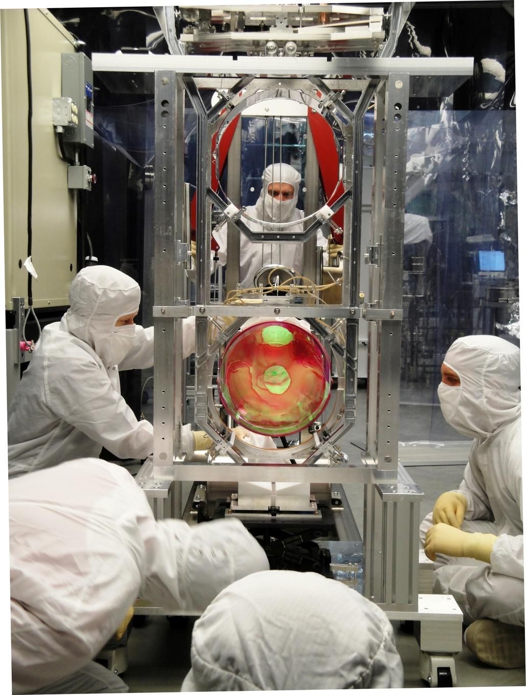 LIGO scientists working on its optics suspension.