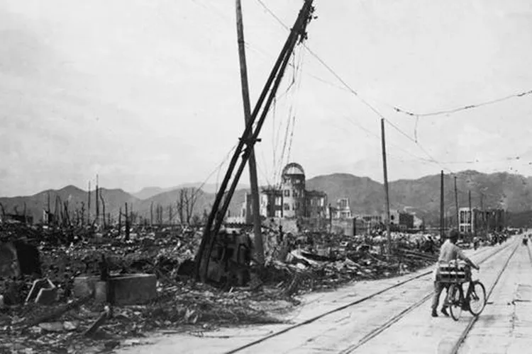 Man wheels bicycle through Hiroshima (mobile)