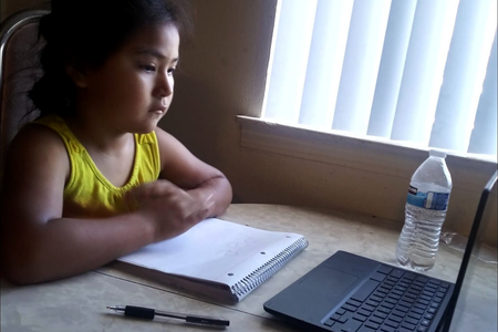 A Diné child begins her much-anticipated school year online in Albuquerque, New Mexico. (Courtesy of Cornillia Sandoval, used with permission)