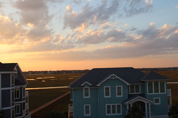 Houses on the water experecing a sunset thumbnail