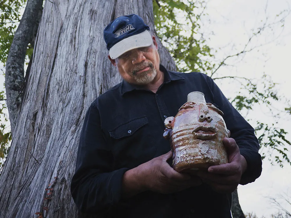Jim McDowell holds his jug, “Emmett Till.” (Photo By Rimas Zailskas, courtesy of Asheville Made Magazine)