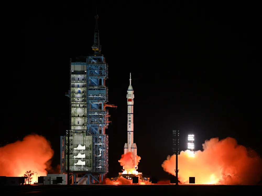 The rocket carrying the spacecraft with the three Chinese astronauts lifts off from Earth