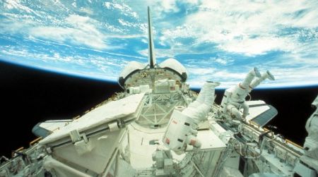 Astronauts float in zero gravity outside the Challenger space shuttle in 1984.