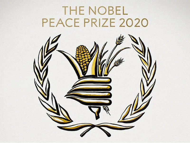 An black and white illustration of a gathering of food-- corn, wheat, surrounded by laurels-- with the text THE NOBEL PEACE PRIZE 2020, with gold accents