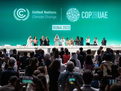 Sultan al-Jaber, the president of COP28, and other participants at the conference applaud. The final document resulting from COP28 mentioned transitioning away from fossil fuels, rather than phasing them out over time.