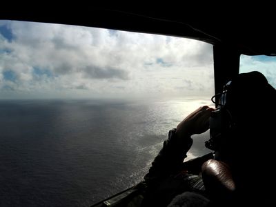 A Royal New Zealand Air Force P-3 searches the Indian Ocean off the coast of Western Australia for debris after the Malaysian airliner vanished.