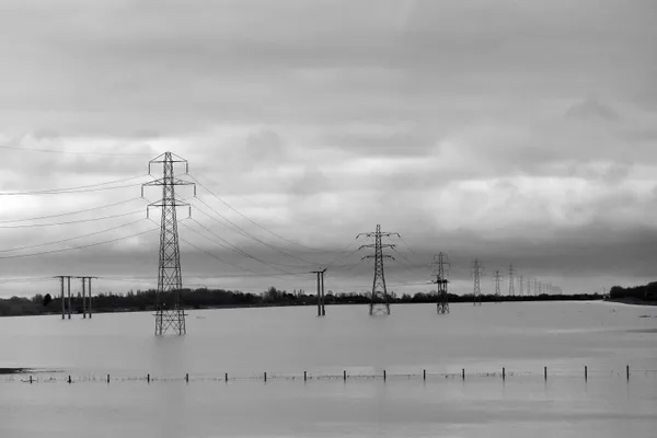 A waterlogged field with electricity pylons submerged thumbnail