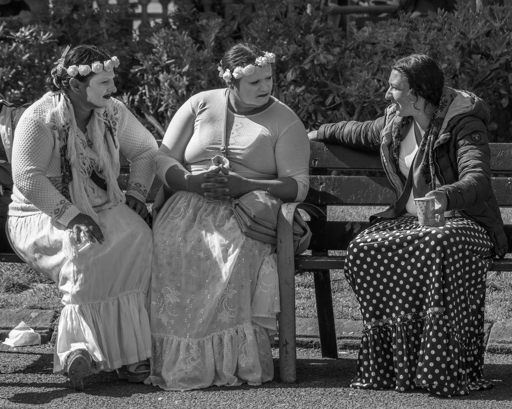Street performers conversing between performances in the park.