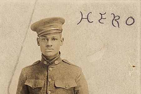 Cpl. Lawrence McVey poses at attention in a photographic postcard. The word "Hero" is inscribed at the top.
