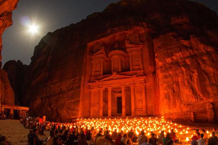 Visitors sit in front of Petra's famous temple at night. Nearby, Google Earth and drones helped researchers find a previously undiscovered platform probably used for ceremonial purposes.