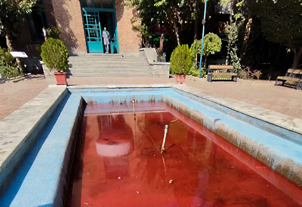 A fountain with its water dyed red outside the Artists' Forum at Honarmandan Park in the Iranian capital Tehran