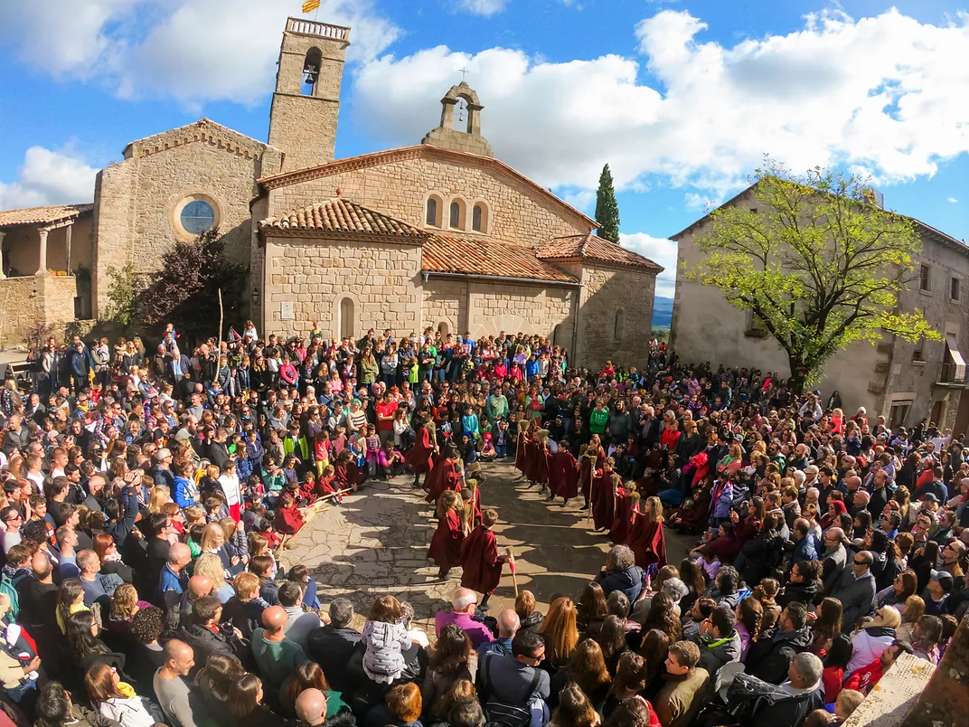 children perform outside in front of a church