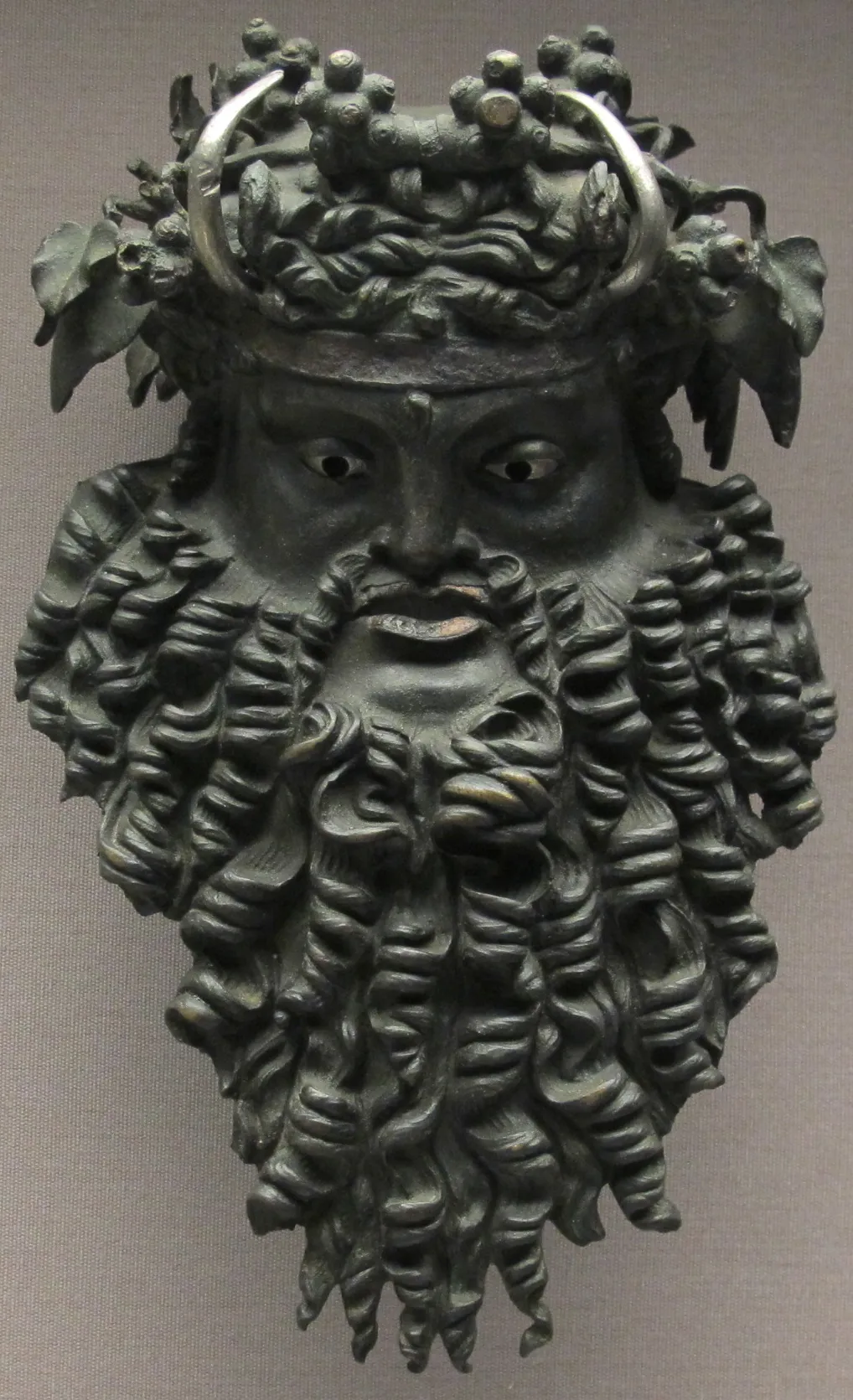 A previously discovered bronze mask of Dionysus