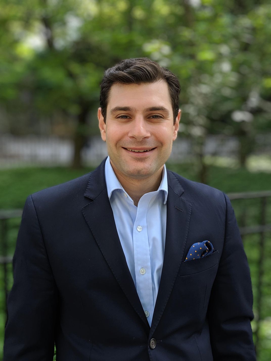 A photo of a man smiling at the camera