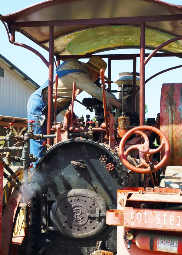 Farmer Adjusting an Old Steam Engine thumbnail